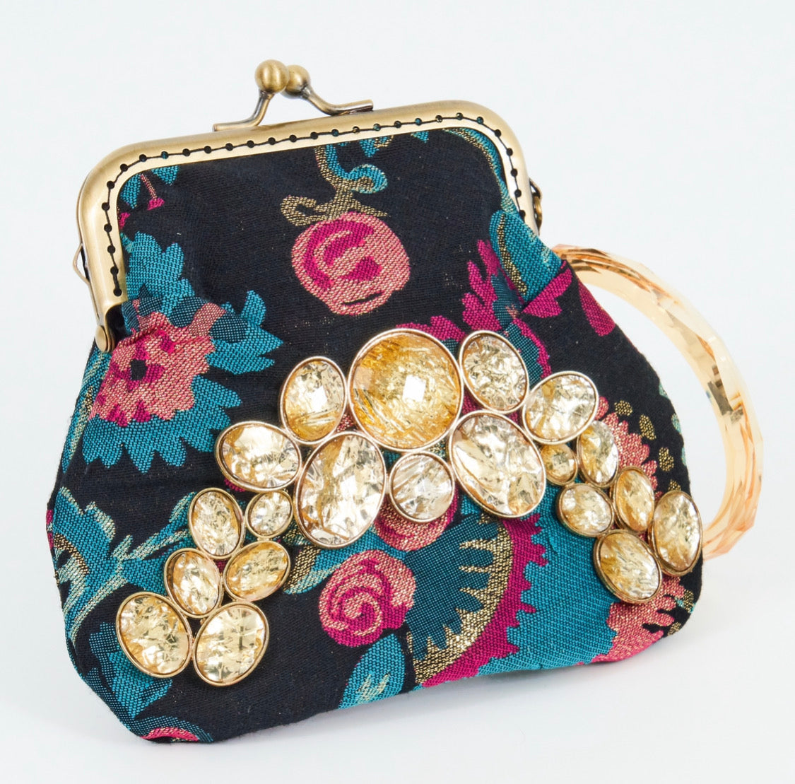 Meet Brigitte. A wristlet purse of black, blue and pink flowers, with a garland of gold rhinestones.