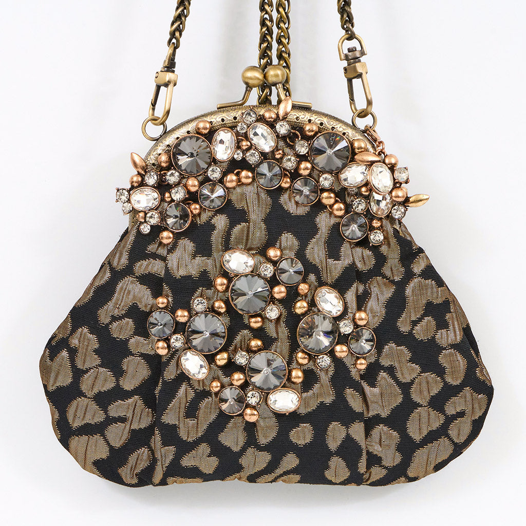 Meet Celeste. A black and gold evening bag with rhinestone embellishments.