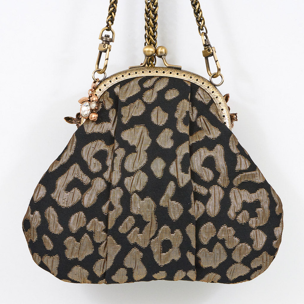 Meet Celeste. A black and gold evening bag with rhinestone embellishments.