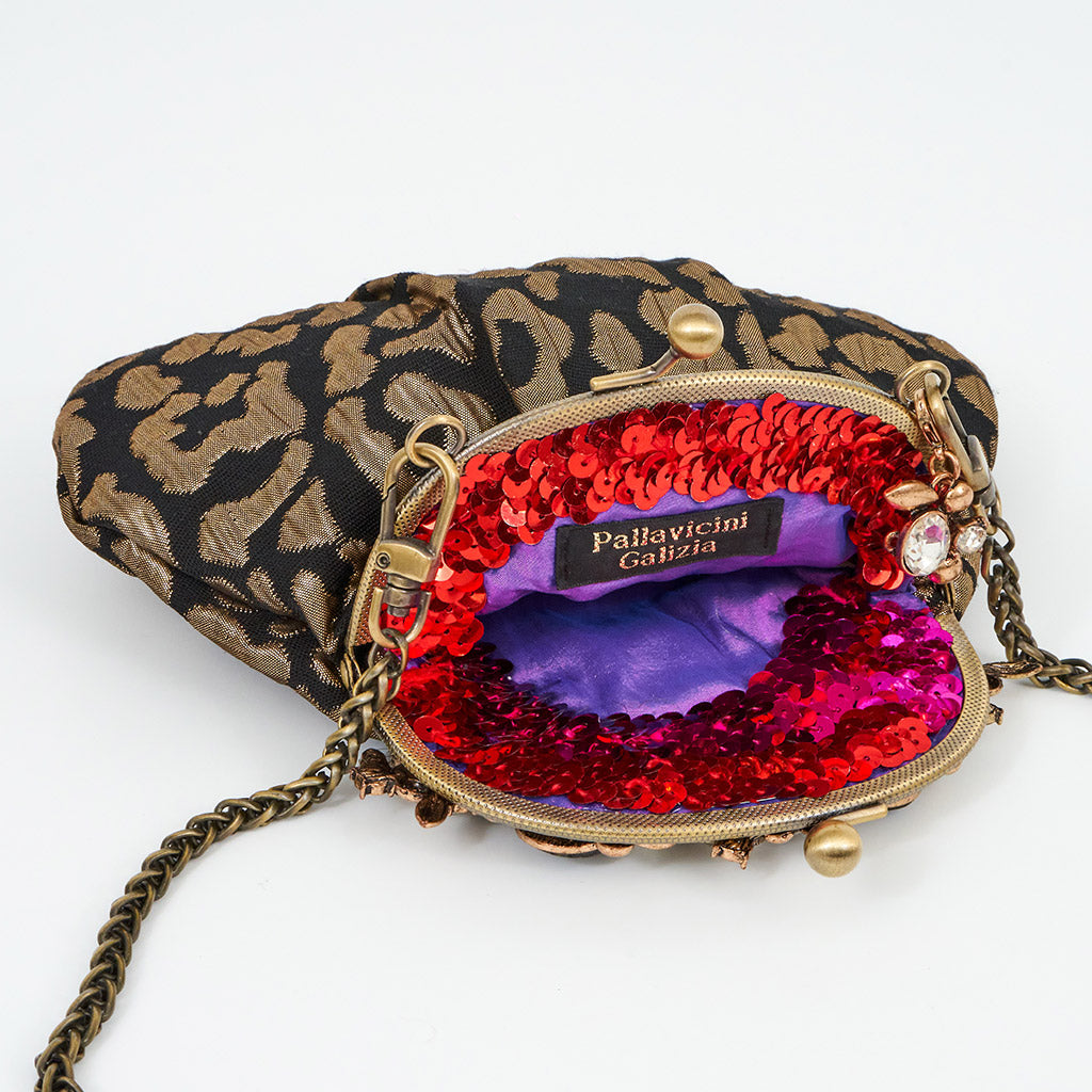 Meet Celeste. A black and gold evening bag with rhinestone embellishments.
