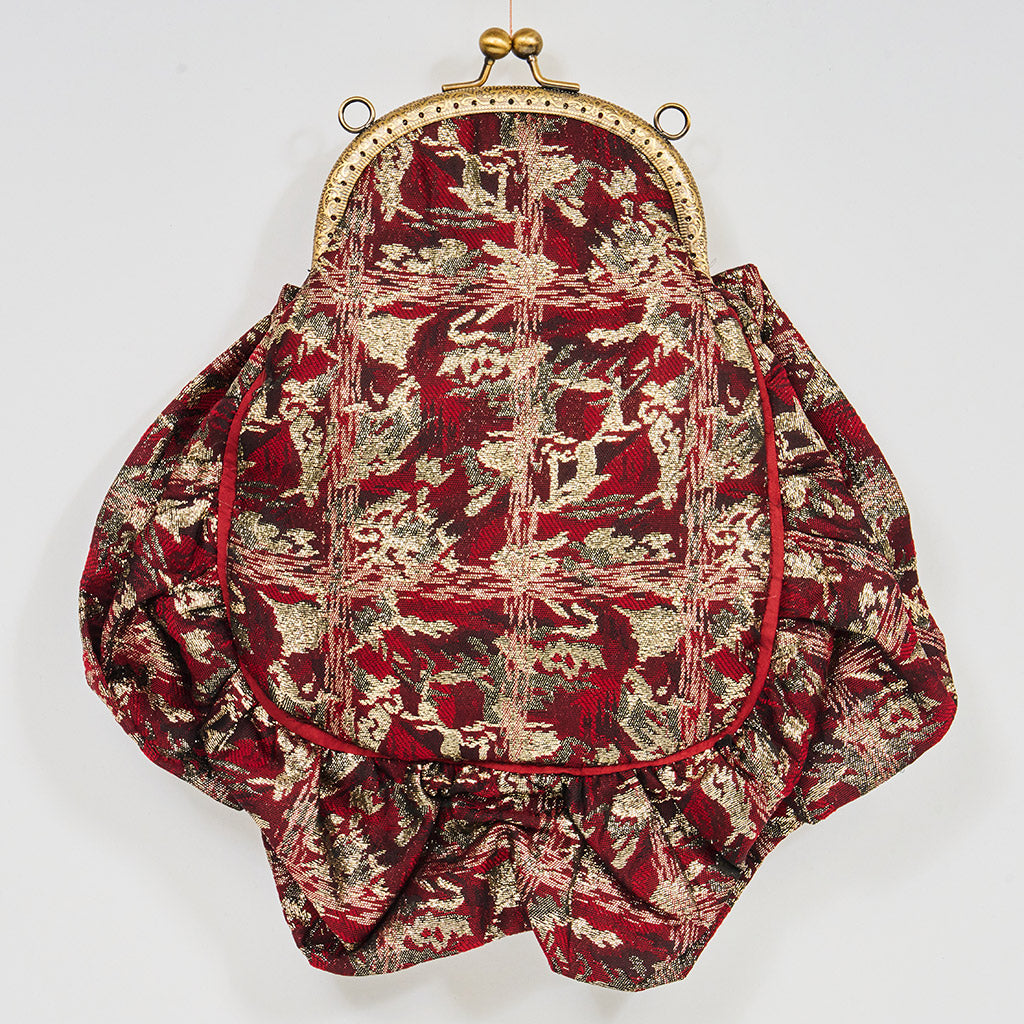 Meet Gapsy. A burgundy, gold & red shimmer handbag, adorned with super size red rhinestones and gold chain features.