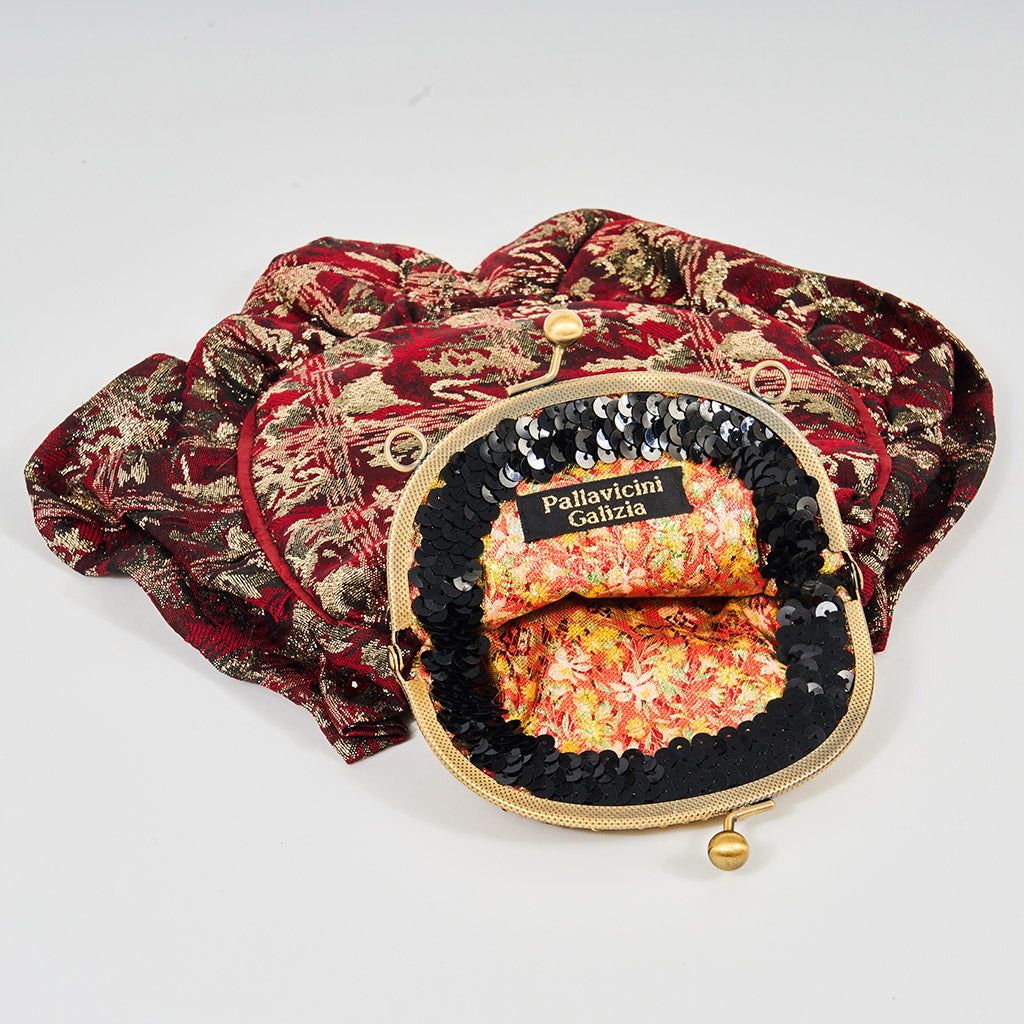 Meet Gapsy. A burgundy, gold & red shimmer handbag, adorned with super size red rhinestones and gold chain features.