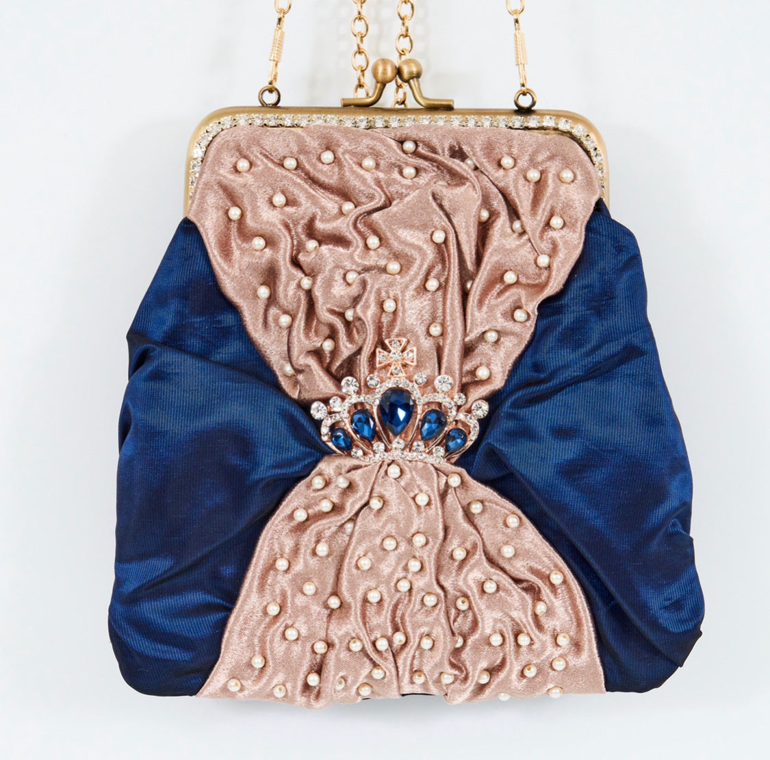 Meet Sandra, a small handbag with a crown centrepiece of blue and white diamonds.