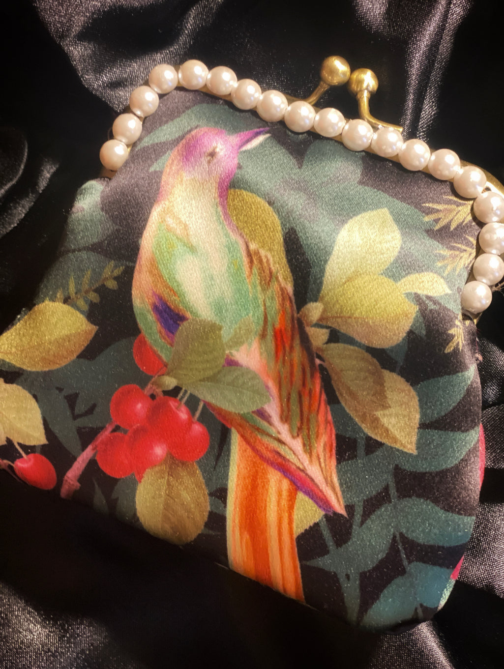 Meet Victoria, A bird inspired satin purse with pink feathers and jumbo pearls.