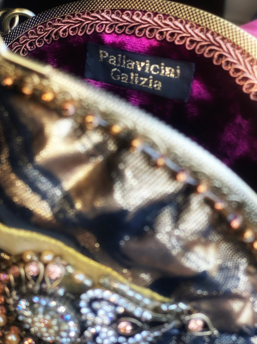 Meet Olympia. A gold, brown and black handbag with circular pearl motifs.