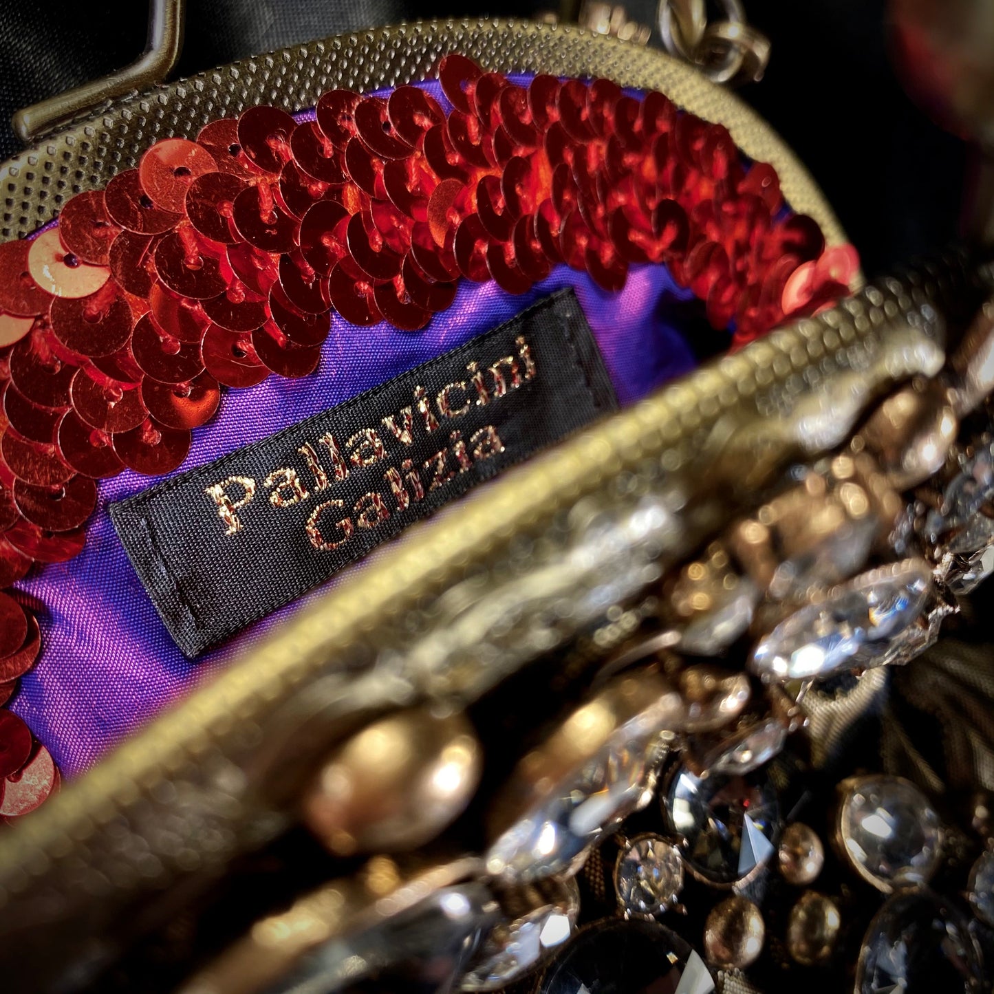 Meet Celeste. A black and gold evening bag with rhinestone embellishments.