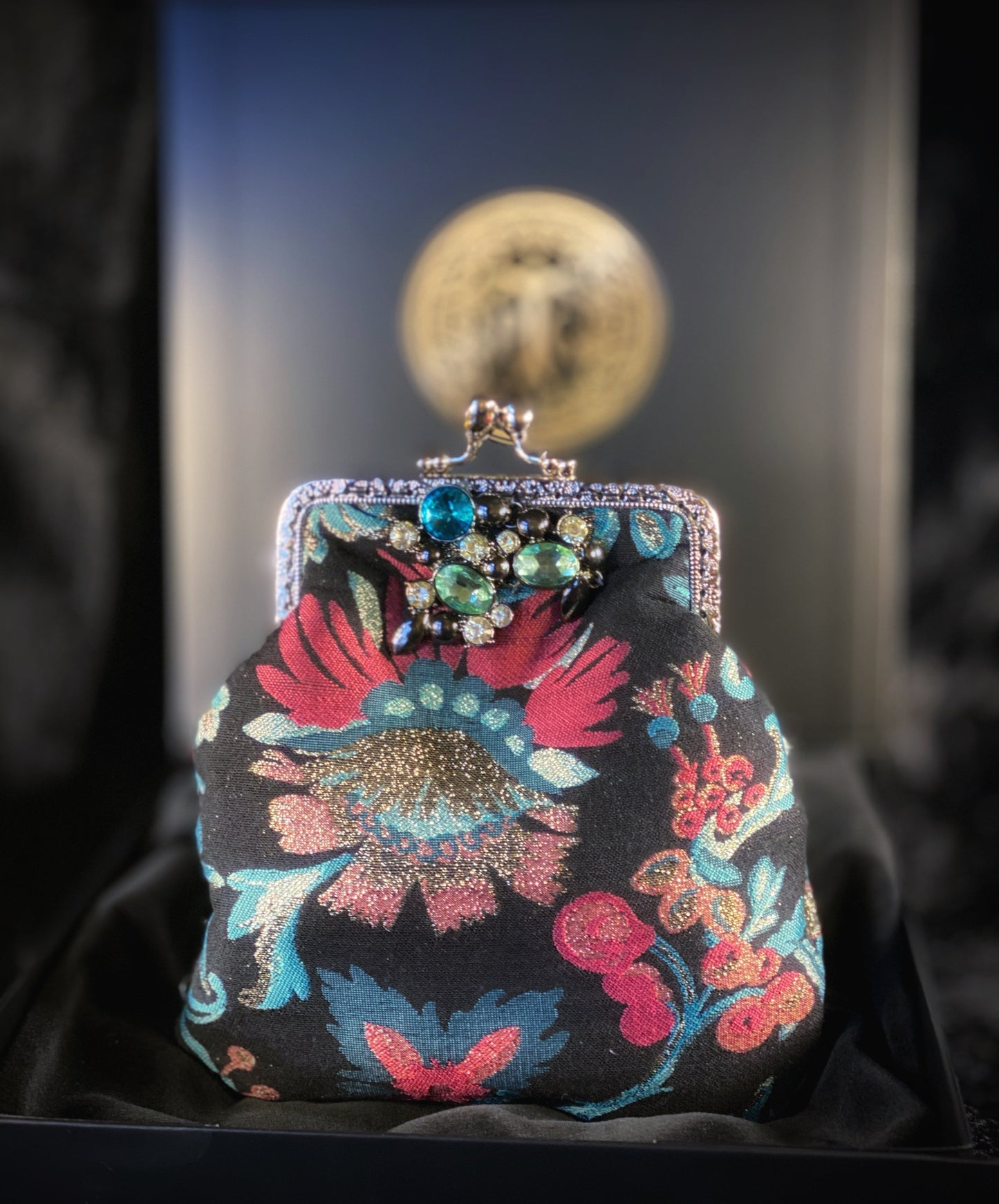 Meet Freda. A blue, pink and black wristlet purse with garland style, rhinestone embellishment.