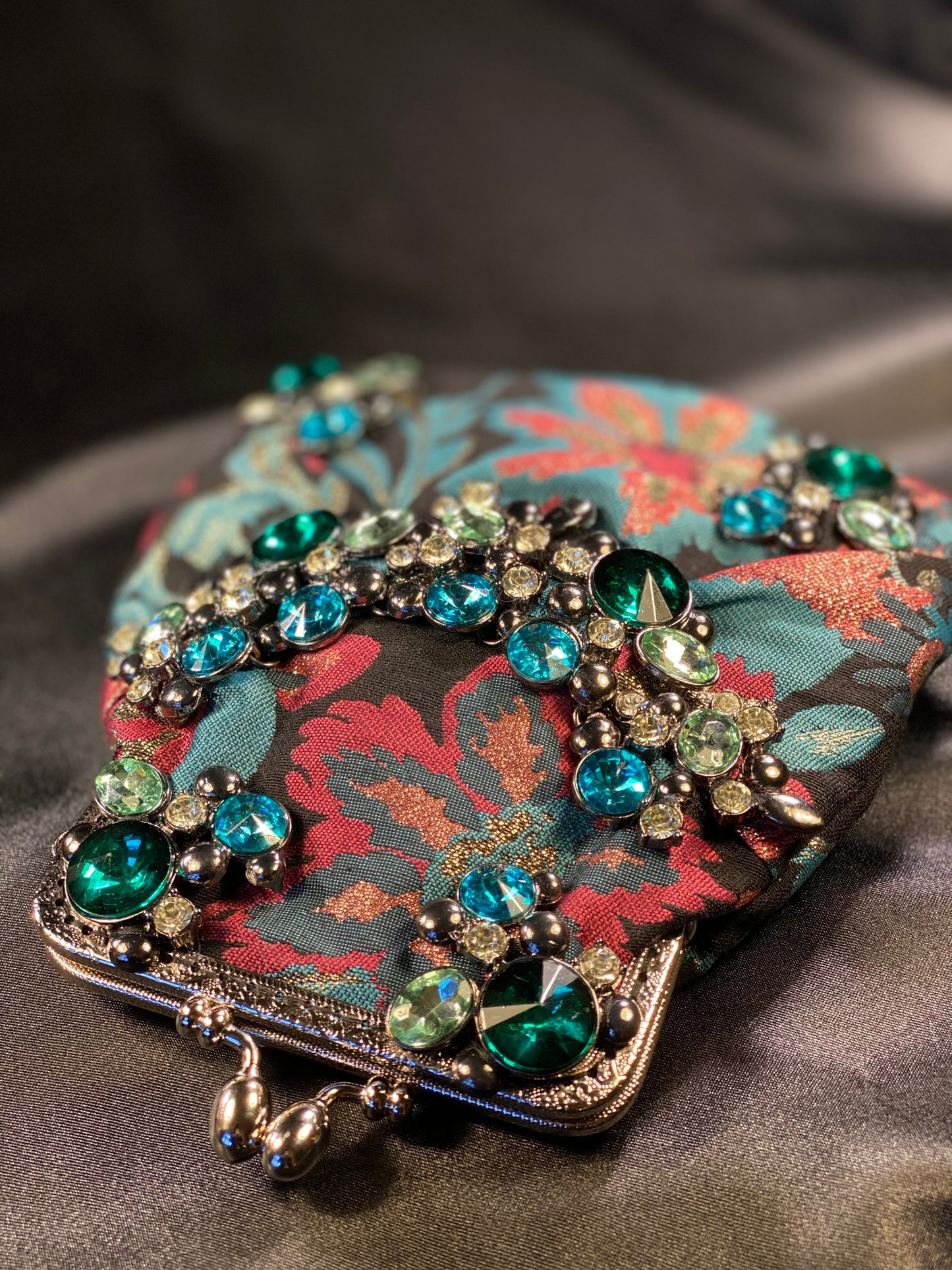 Meet Freda. A blue, pink and black wristlet purse with garland style, rhinestone embellishment.