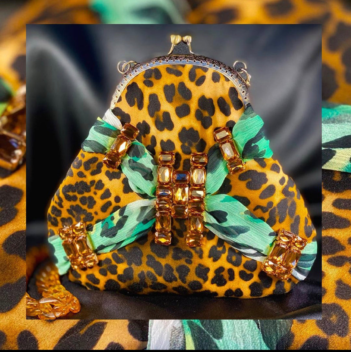 Meet Tabatha. A leopard print and green textile handbag with bronze rhinestones.