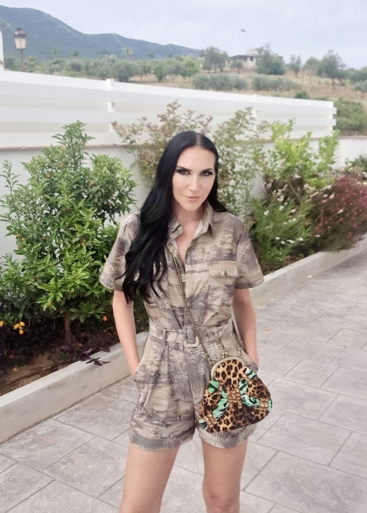 Meet Tabatha. A leopard print and green textile handbag with bronze rhinestones.