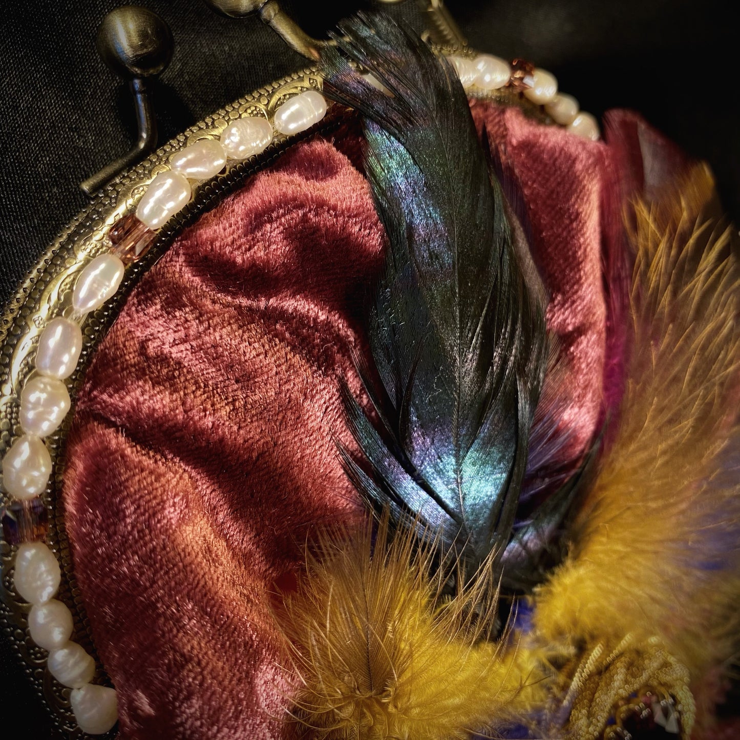 Plumb velvet & multicolour feather handbag with a pearl and amethyst trim.