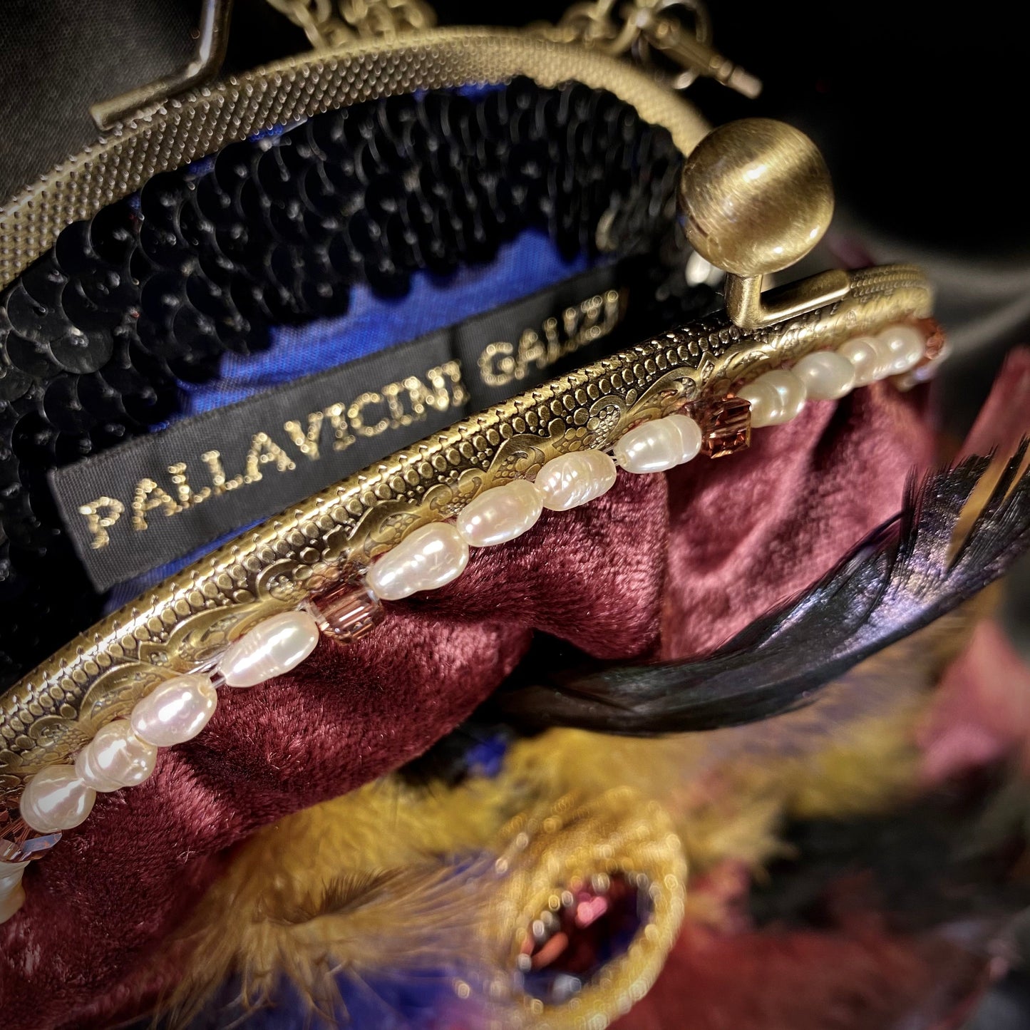 Plumb velvet & multicolour feather handbag with a pearl and amethyst trim.