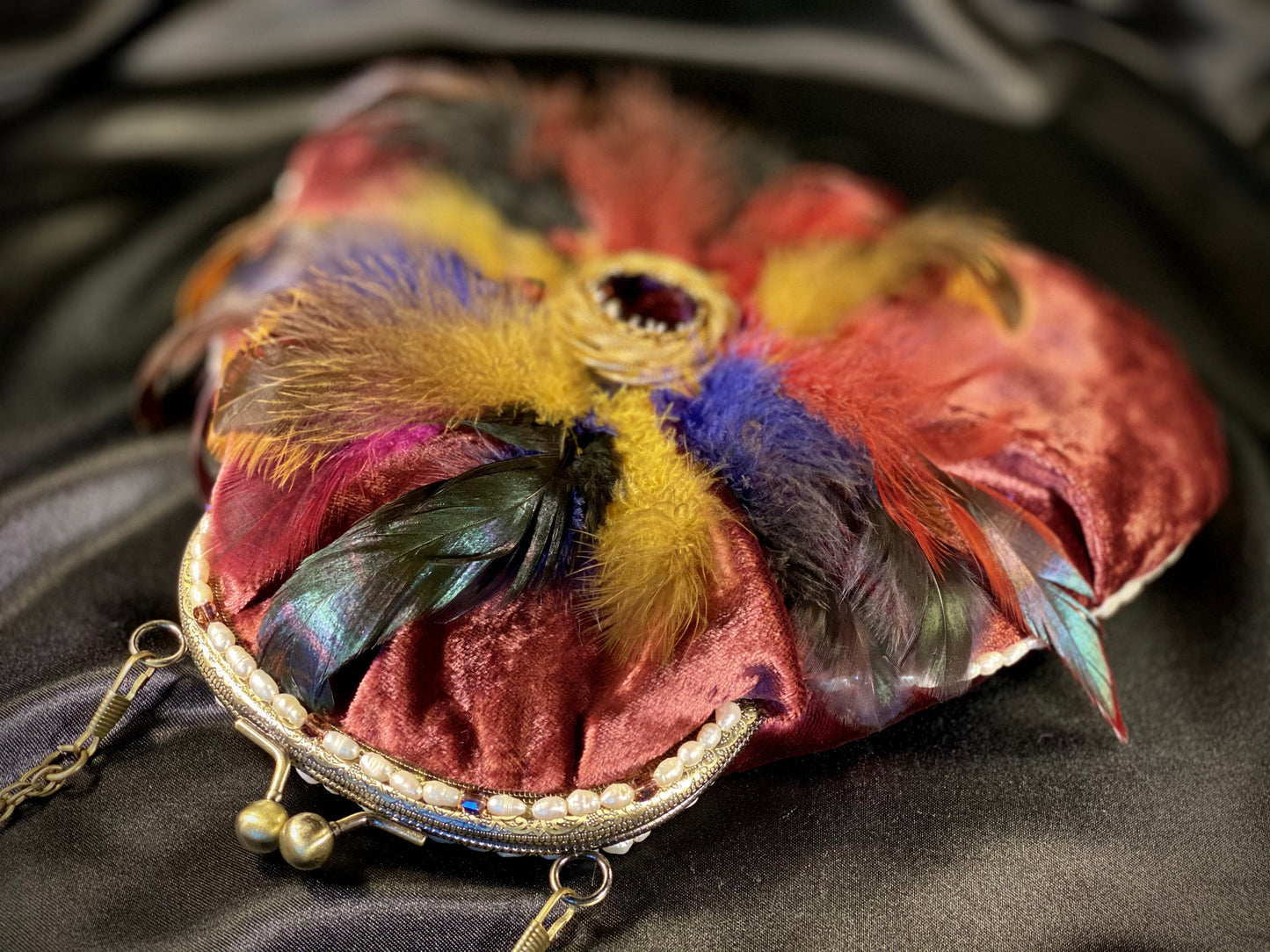 Plumb velvet & multicolour feather handbag with a pearl and amethyst trim.