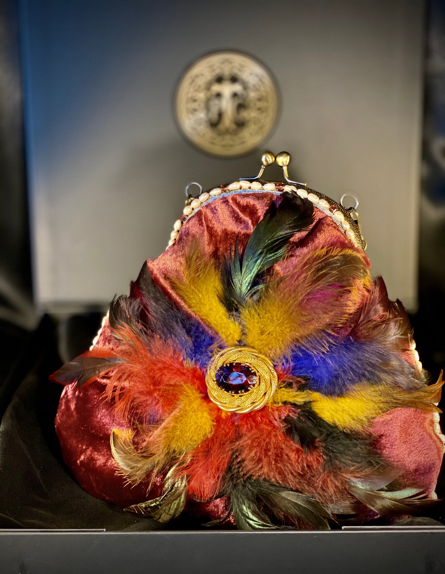 Plumb velvet & multicolour feather handbag with a pearl and amethyst trim.