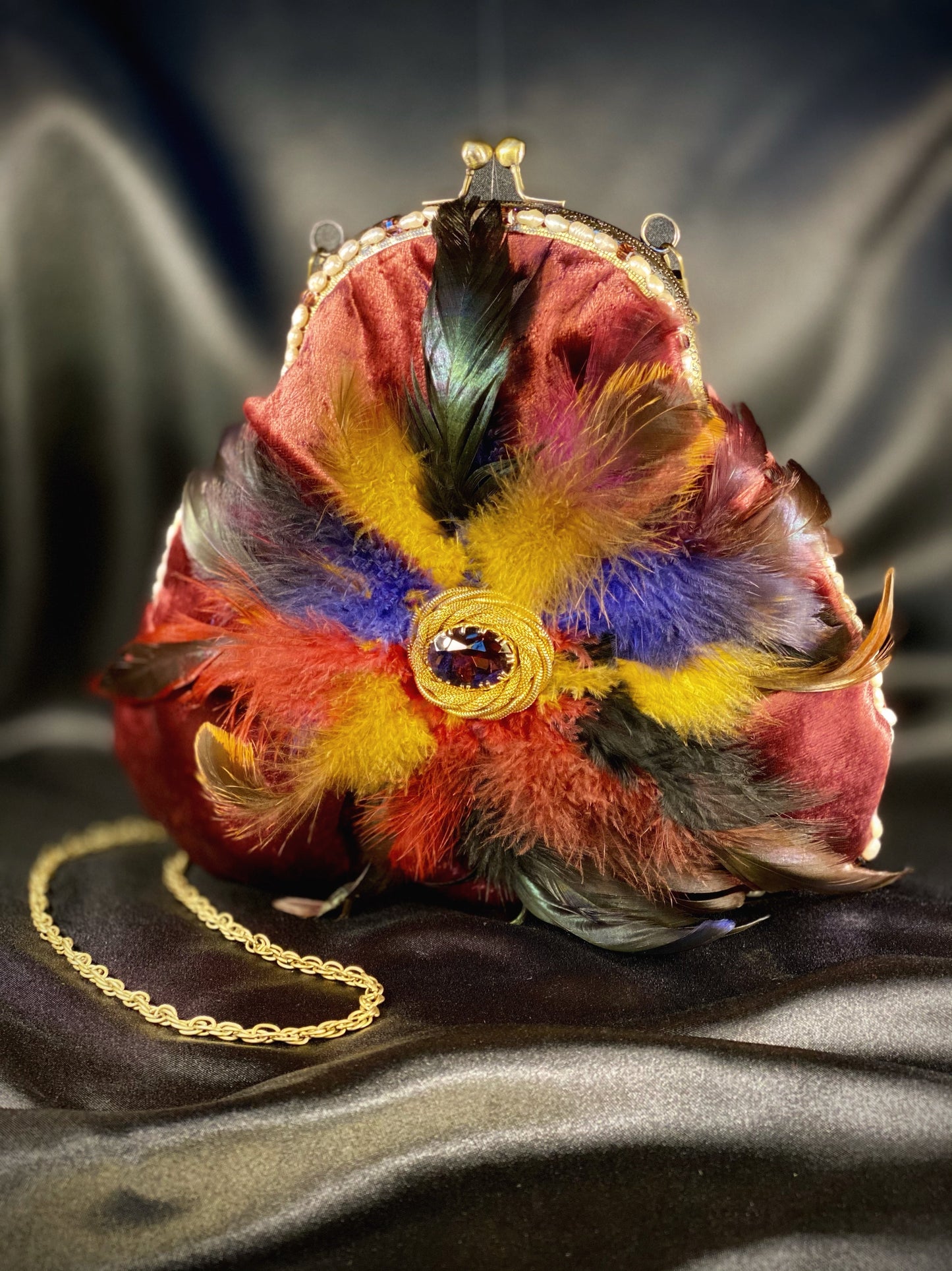 Plumb velvet & multicolour feather handbag with a pearl and amethyst trim.