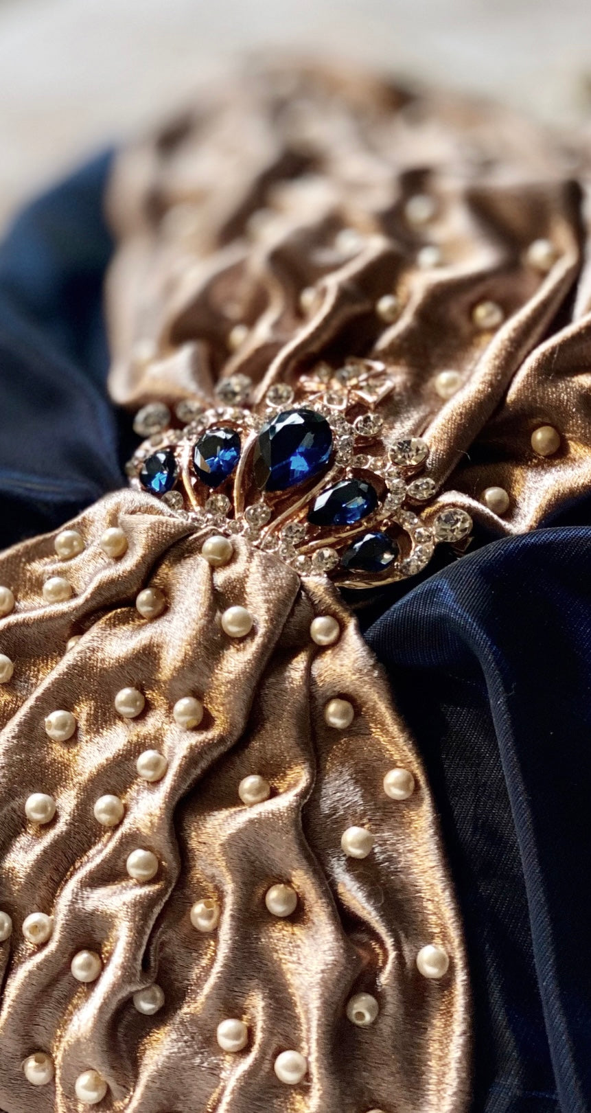 Meet Sandra, a small handbag with a crown centrepiece of blue and white diamonds.