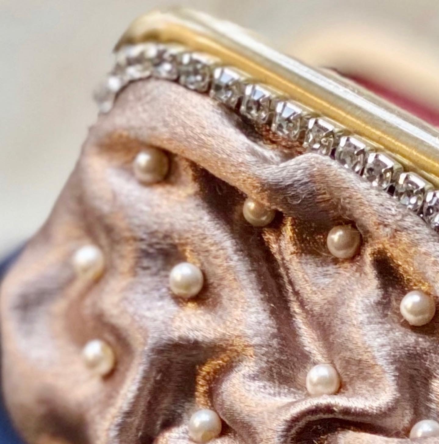 Meet Sandra, a small handbag with a crown centrepiece of blue and white diamonds.
