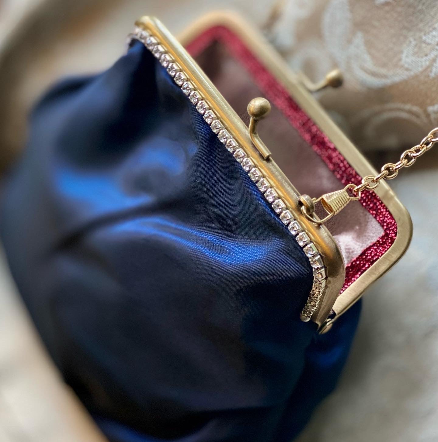 Meet Sandra, a small handbag with a crown centrepiece of blue and white diamonds.